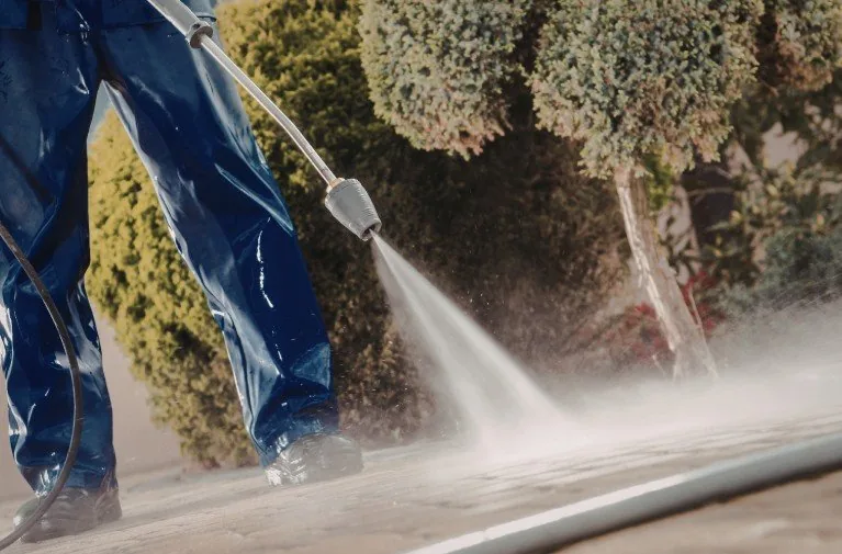 Pressure washing crew rinsing a commercial walkway